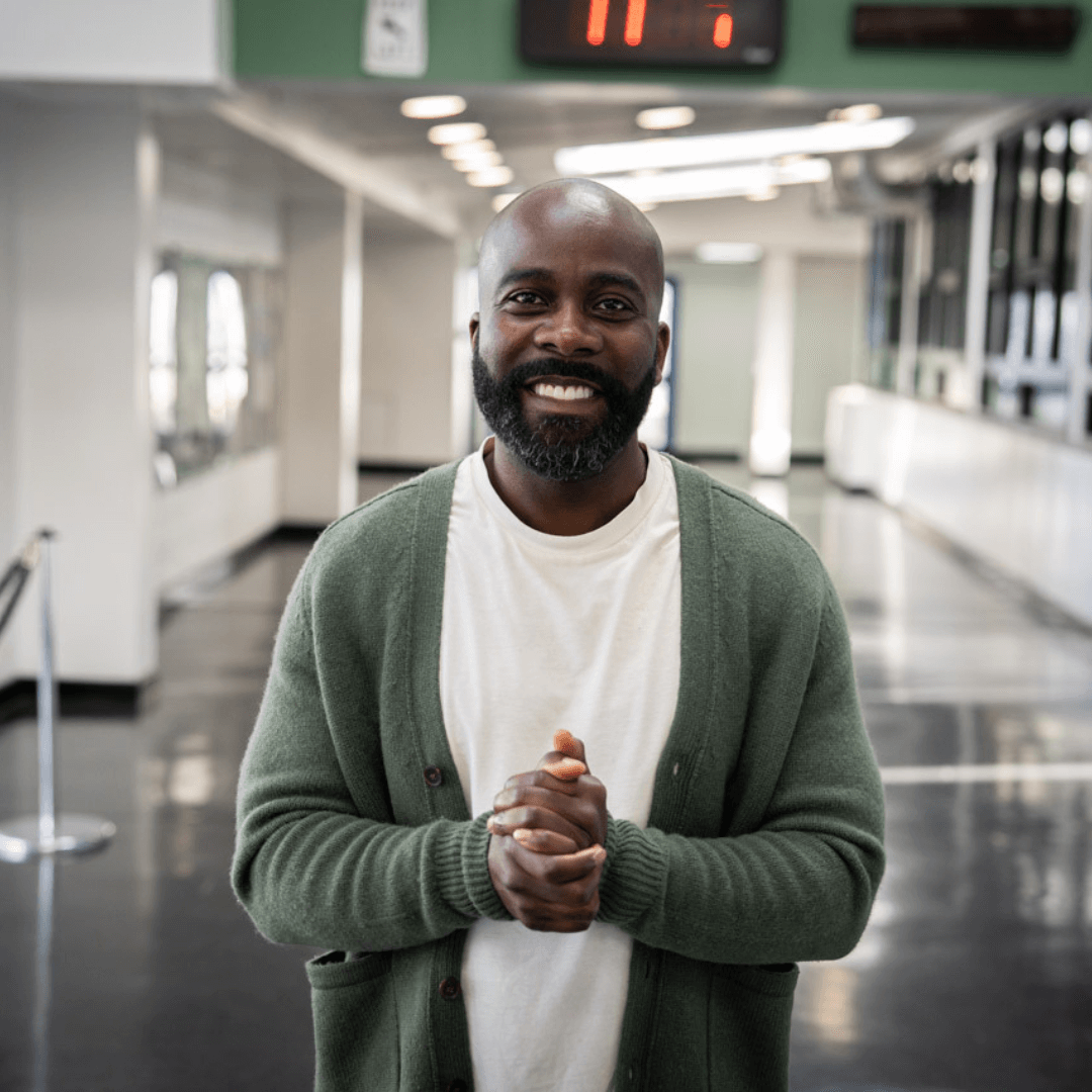 Man smiling with hands together