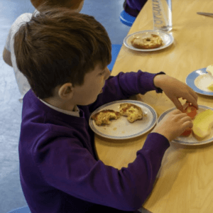 child eating breakfast at magic breakfast club