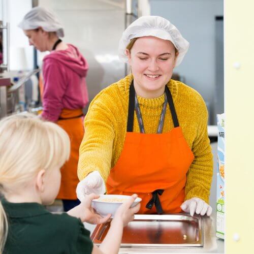 A picture of a woman serving breakfast