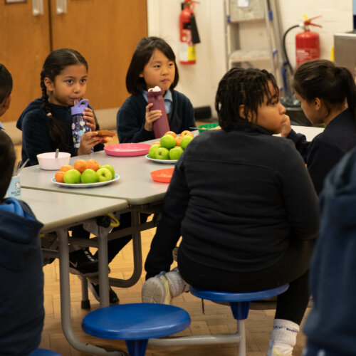 Group of school children having breakfast