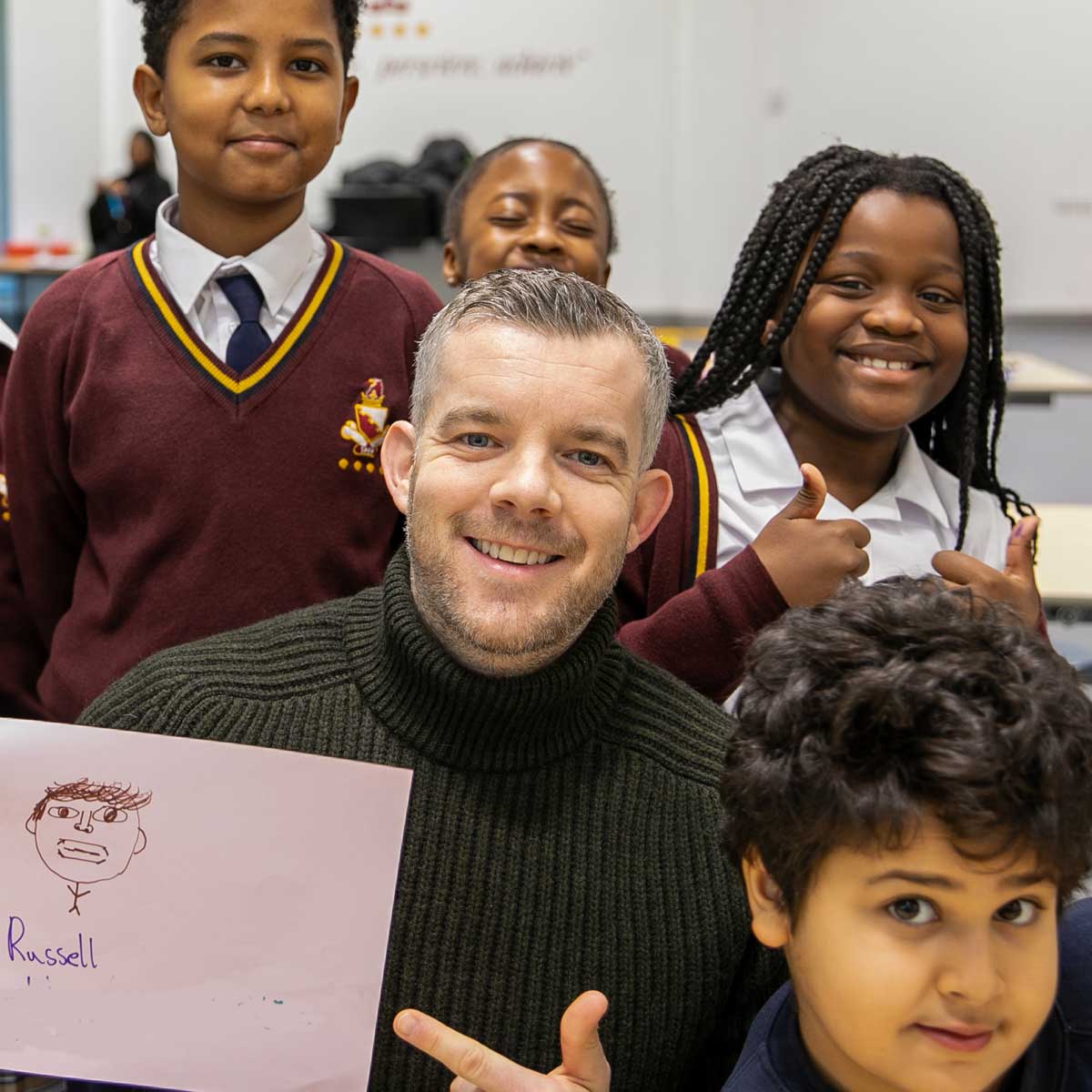 A picture of Russell Tovey with children