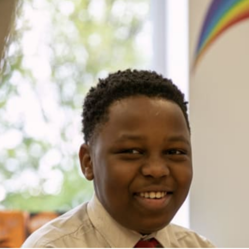 A primary school boy smiling in his uniform