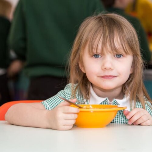 Young child eating breakfast