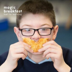 A picture of a child holding a slice of toast in the shape of a smile in front of his mouth for the Annual report 2019-20