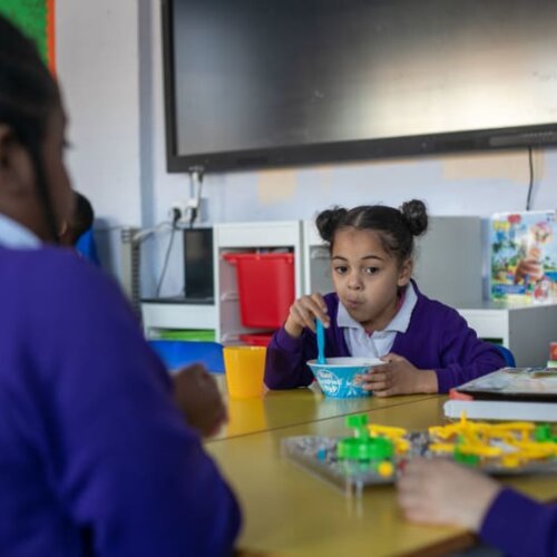 Photo of children eating breakfast at school.