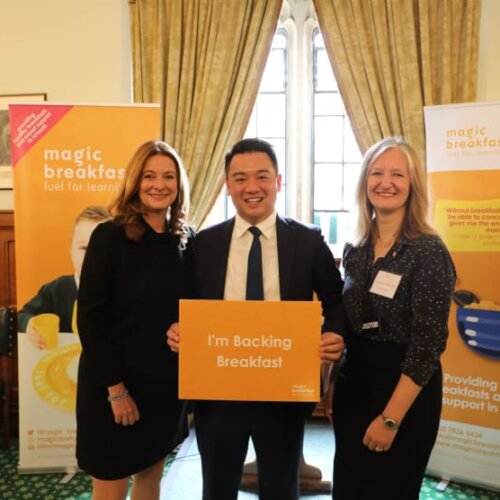 Photo of people in smart clothes at Magic Breakfast event in Parliament.