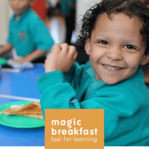 Photo of child smiling at camera during Magic Breakfast.