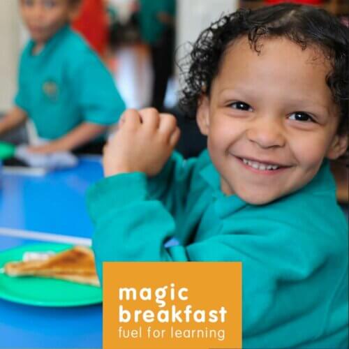 Kid smiling at Magic breakfast