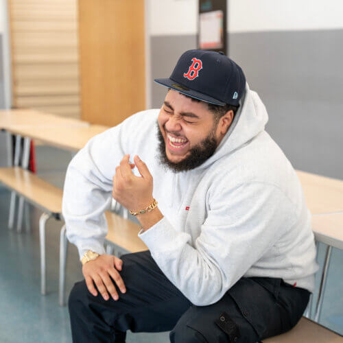 Big Zuu laughing at school table