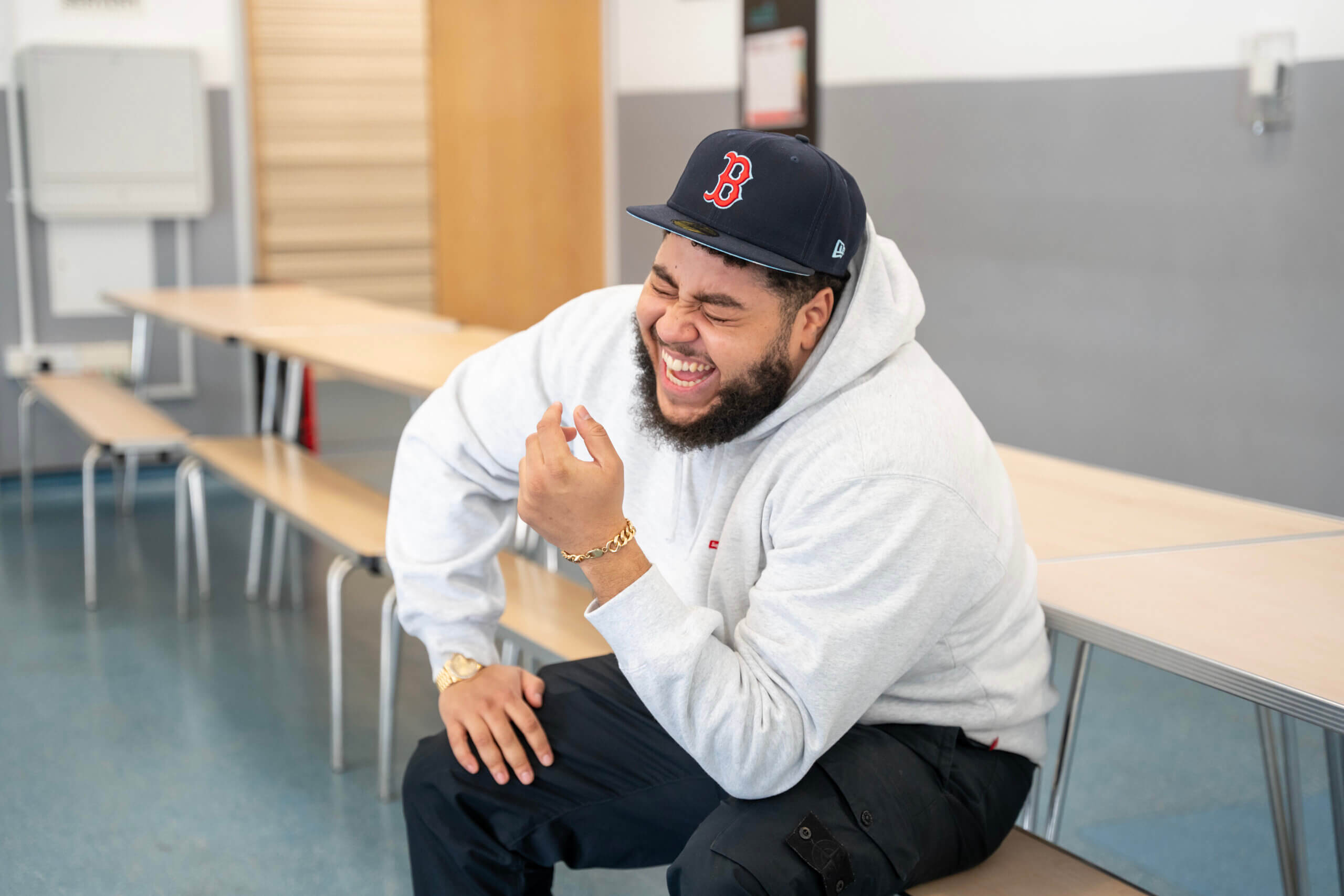 Big Zuu laughing at school table