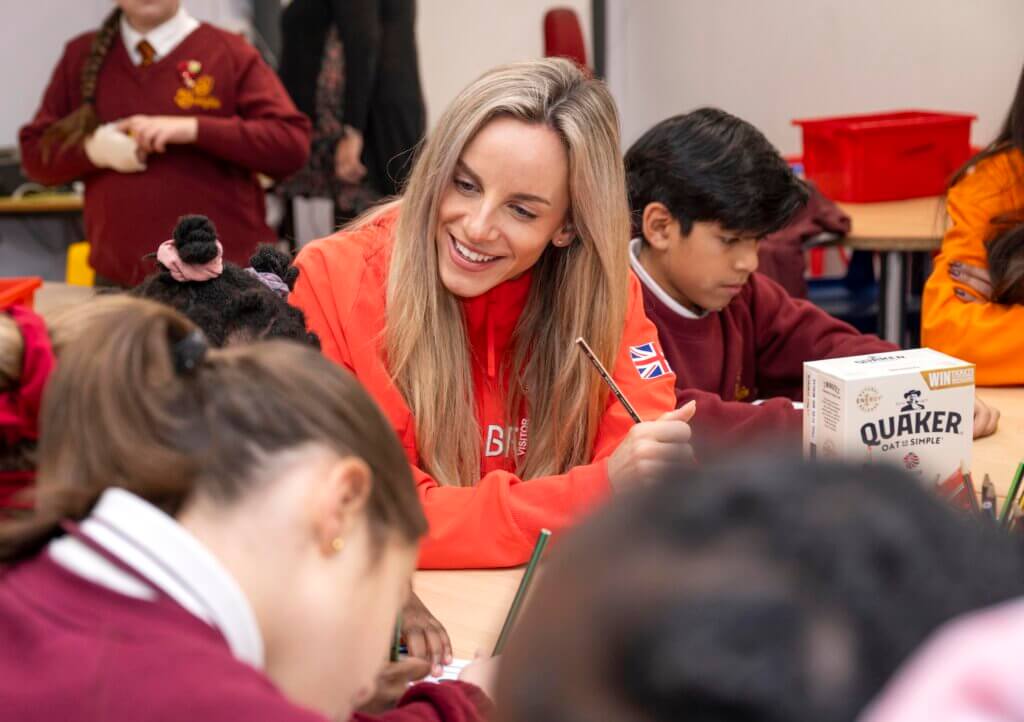 Georgia Hunter Bell, Team GB athlete, with children at a breakfast club table