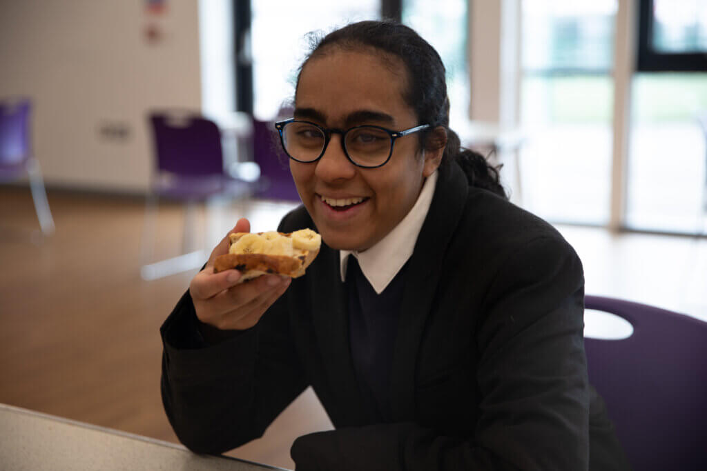 Student at a Magic Breakfast SEND school sits at the breakfast table as they eat their breakfast