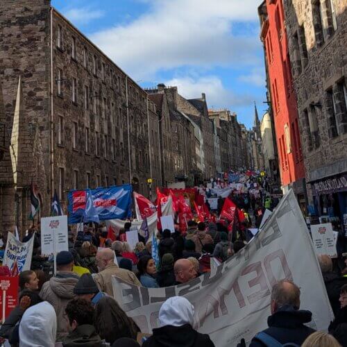 Image of the march moving up the historic Canongate in Edinburgh
