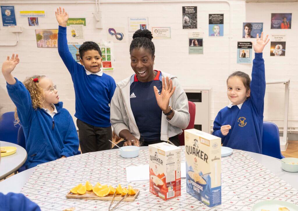 Team GB athlete Christine Ohuruogu at a breakfast club table with multiple children
