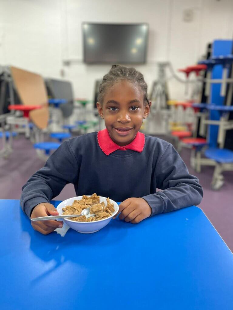 Image showing a child eating cereal at a Magic Breakfast partner school.