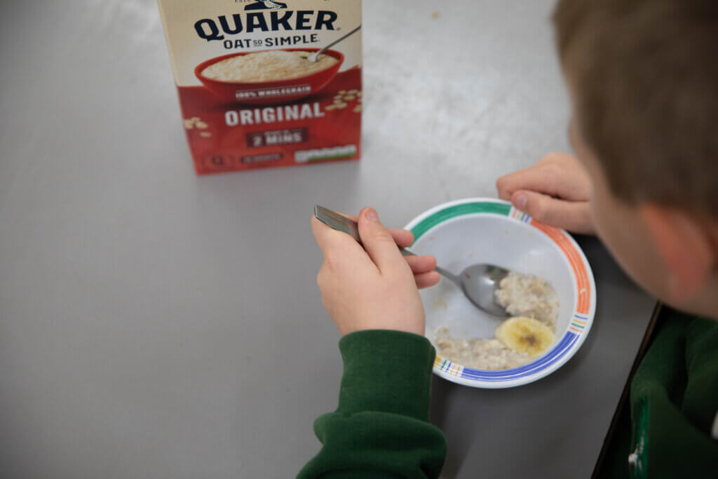 Child eating bowl of porridge