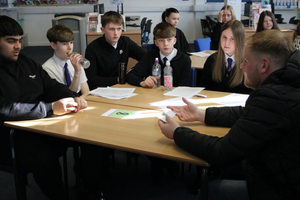 Image of children and young people talking to a partner staff member at a Magic Breakfast Aspiration Day.