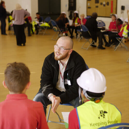 Image of children and young people talking to a partner staff member at a Magic Breakfast Aspiration Day.