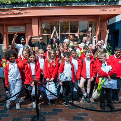 Image of pupils at a Magic Breakfast partner school outside a Dishoom location.