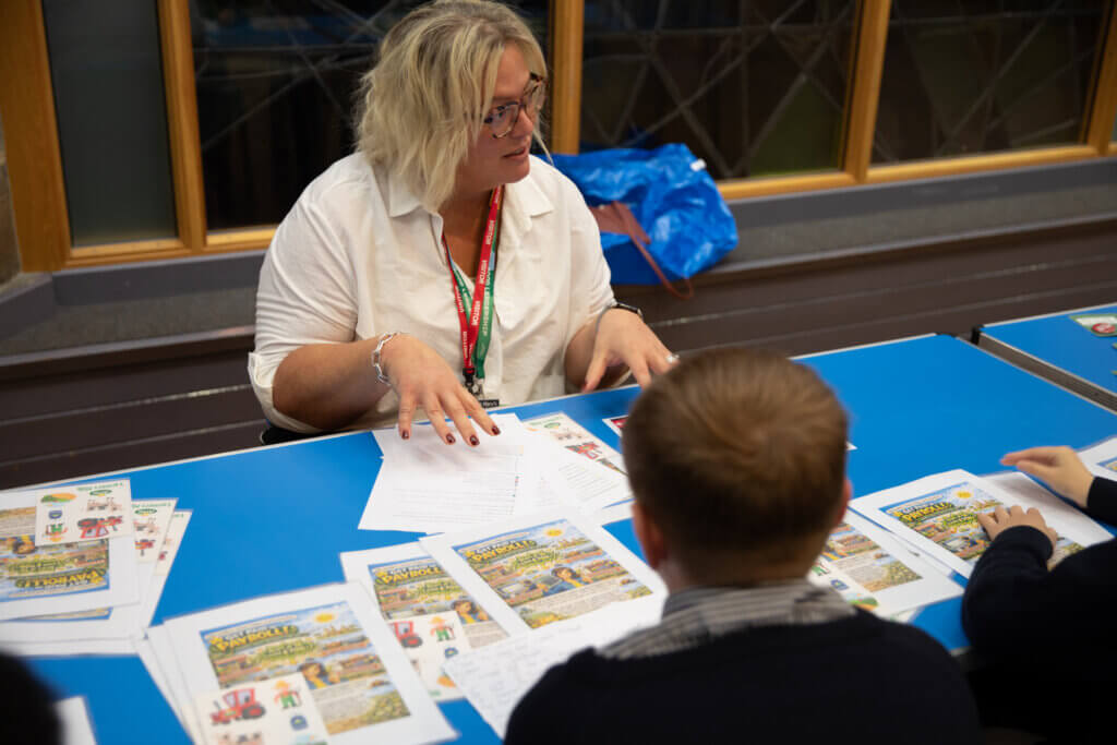 Image of children and young people talking to a partner staff member at a Magic Breakfast Aspiration Day.