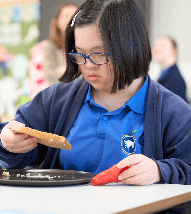 An SEND student branches out to try new things at school breakfast - this time a slice of toast!