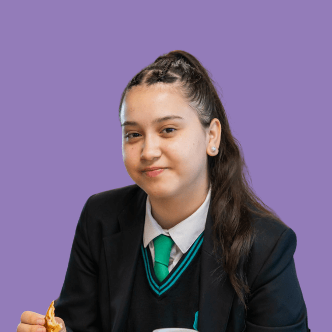 A young student smiles at the camera