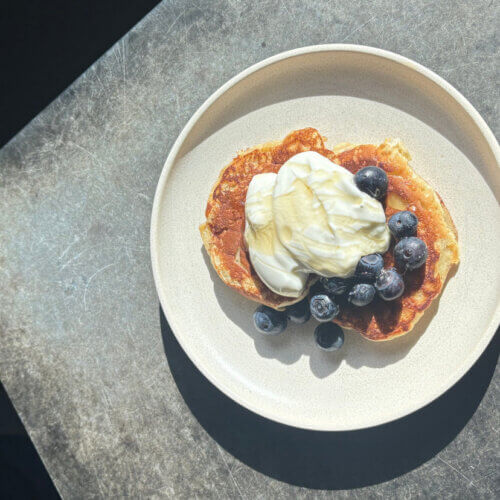 Banana pancakes in a bowl with yoghurt and blueberries